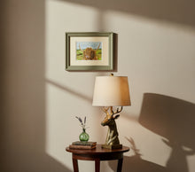 Load image into Gallery viewer, highland cow by a loch colouered pencil drawing by Helen Elizabeth Studios
