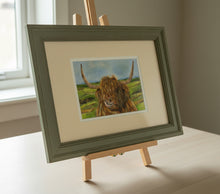 Load image into Gallery viewer, highland cow by a loch colouered pencil drawing by Helen Elizabeth Studios
